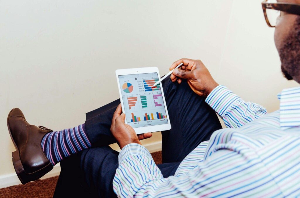 A man holding his ipad and checking his current statements