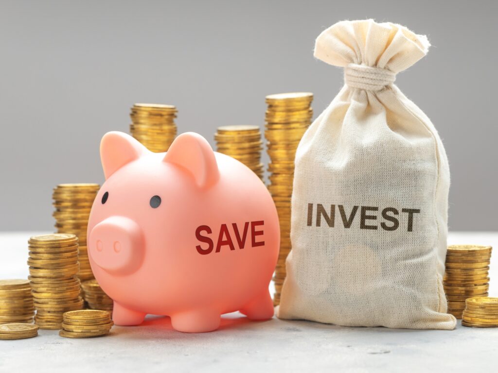 A photo of piggy bank and a bag of coins