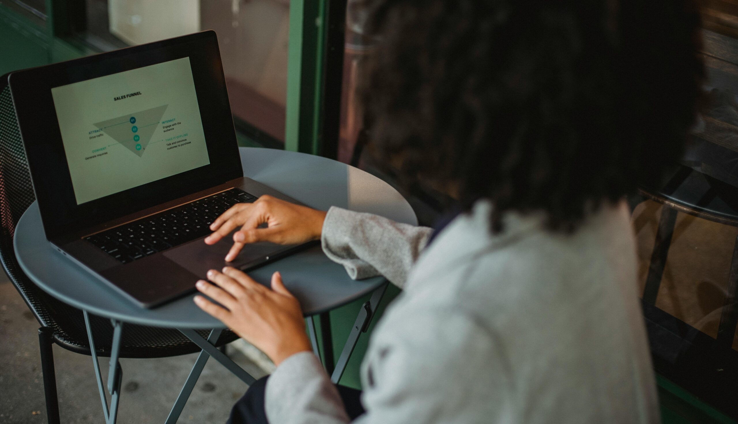 A woman analyzing financial diagram on laptop